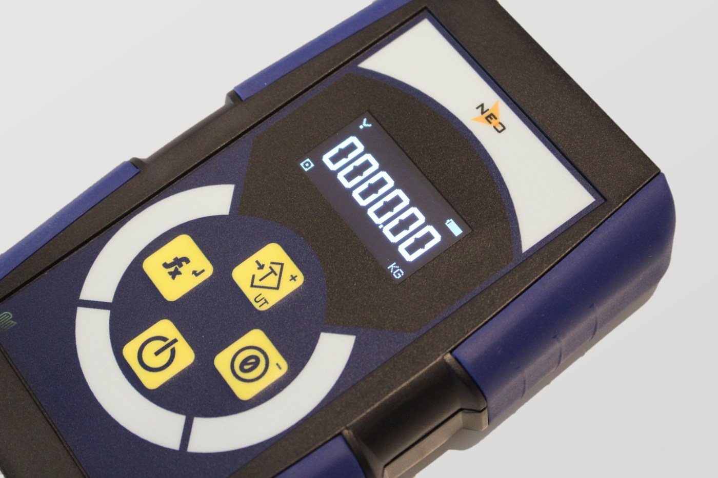 Close-up angled view of the NEO handheld controller, showing the large OLED weight display and four-key keypad