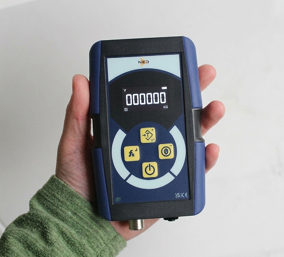 NEO handheld loadcell controller held in one hand, showing the OLED weight display and four-key keypad